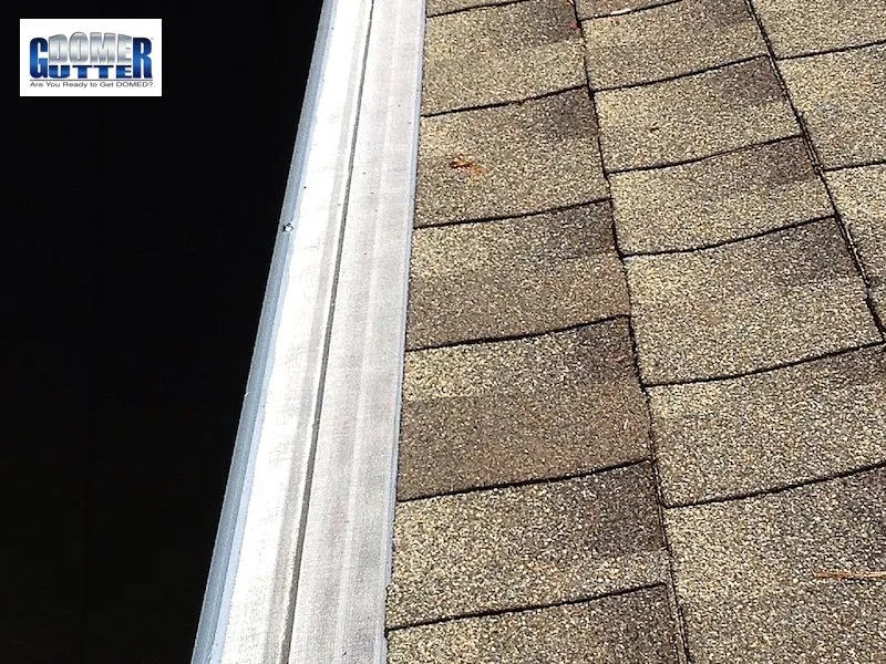 GutterDome extruded aluminum gutter guard installed on brown residential home